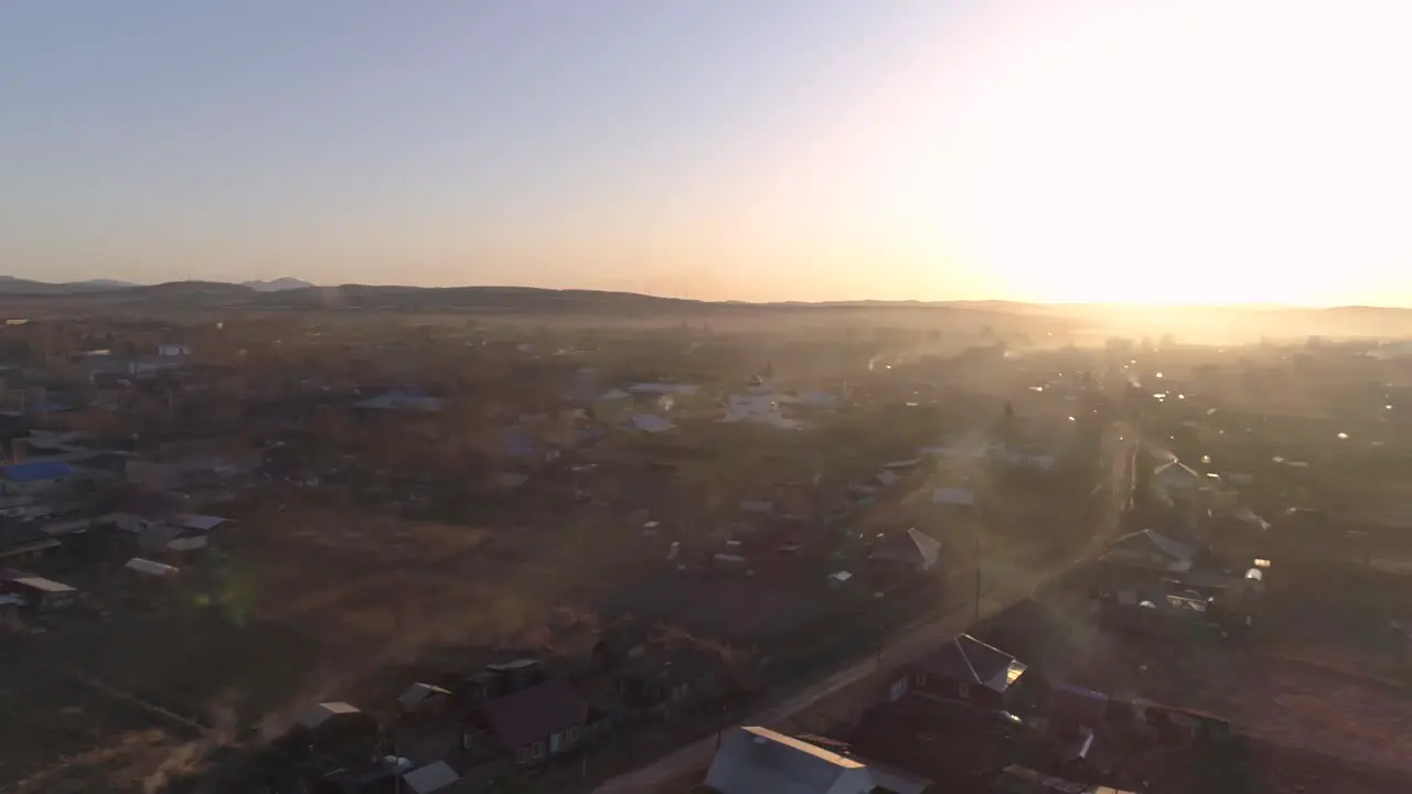 Flying Over Village at Sunset