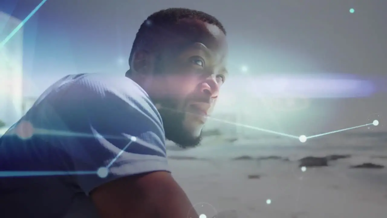 Glowing network of connections against african american man enjoying the view at the beach