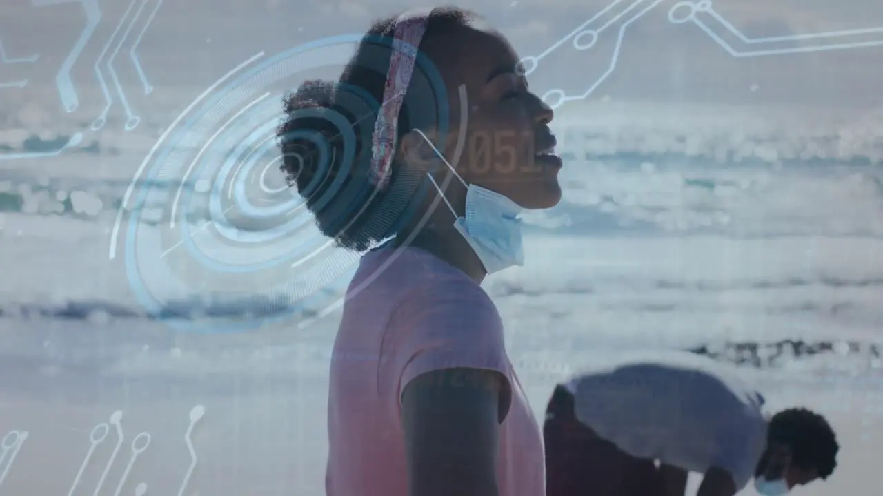 Animation of round scanner and data processing over african american woman enjoying at the beach