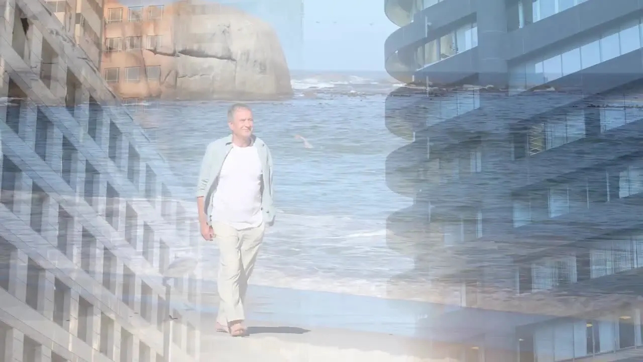 Composite video of tall buildings against caucasian senior man walking at the beach