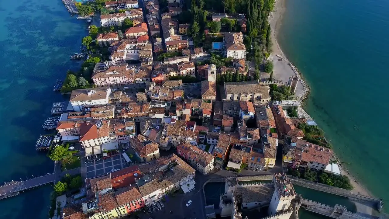 Aerial view of beautiful cityscape with houses and forest surrounded by sea