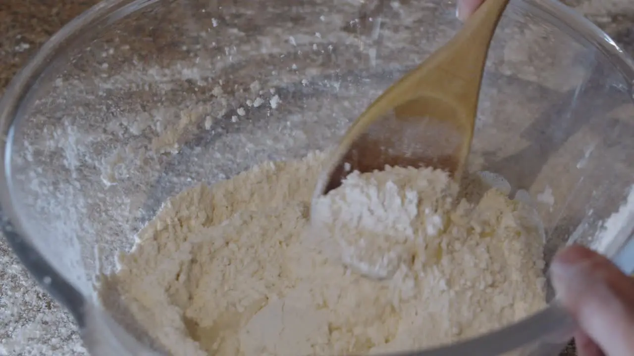 Stirring water olive oil and flour in a glass bowl