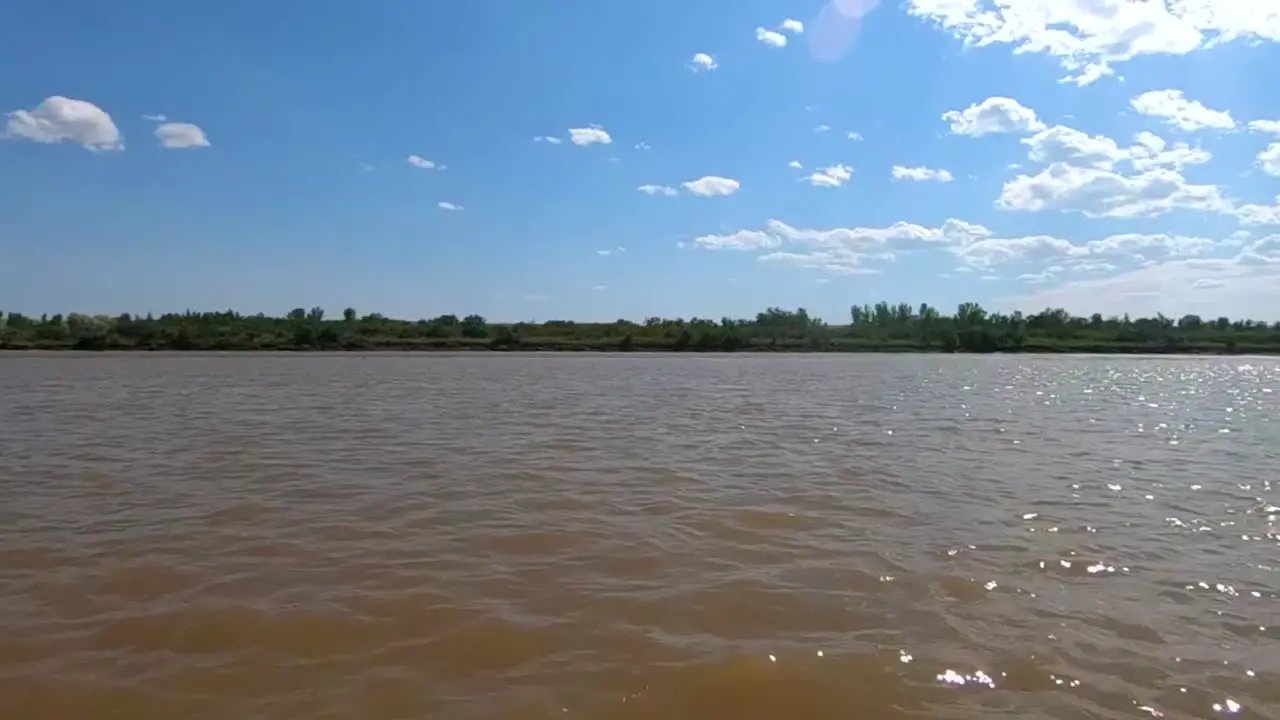 SLOW MOTION Muddy water in a lake on a sunny day in Alberta Canada