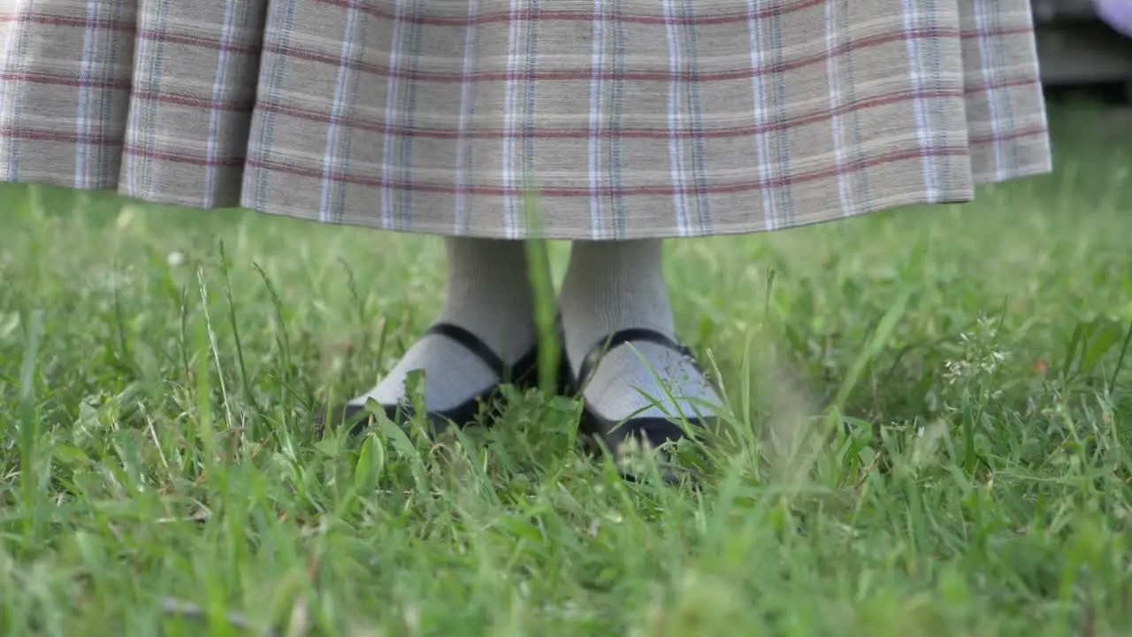 Woman in Folk Costume Sweeping With a Handmade Broom in Slow Motion