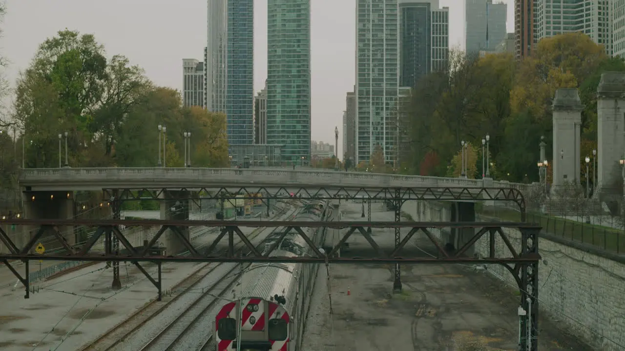 A train travels with buildings in the background in slow-motion