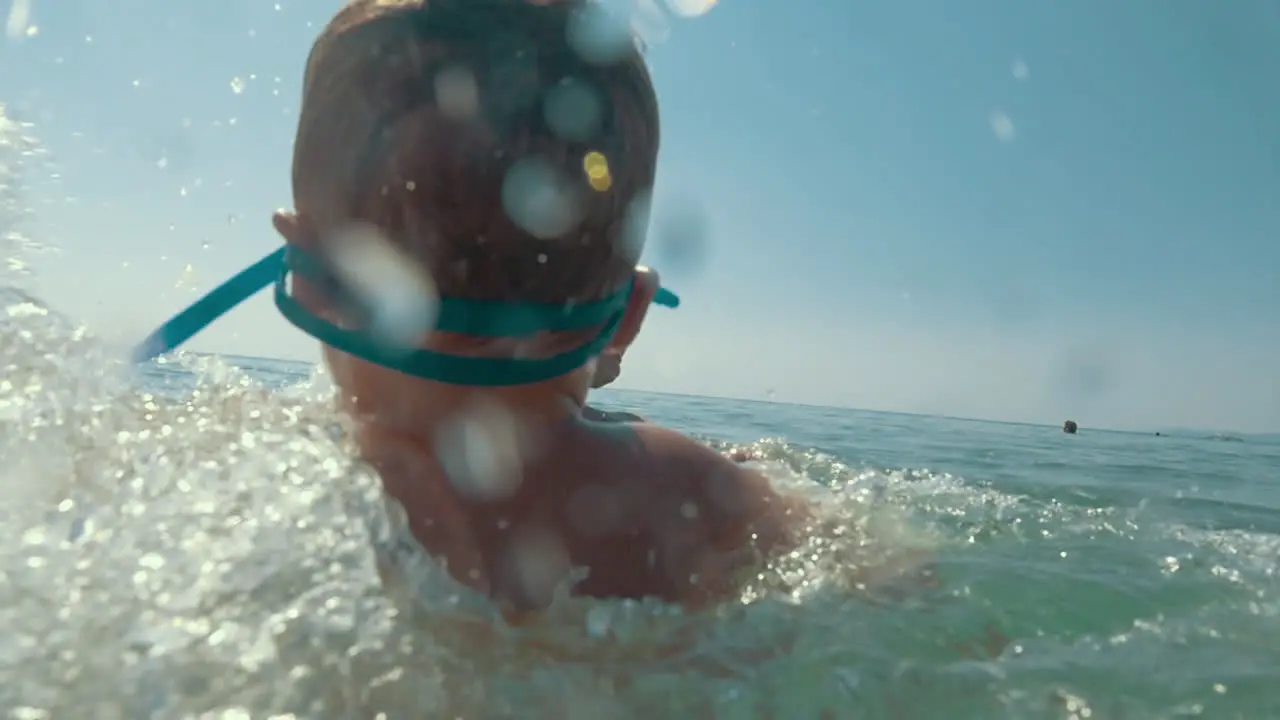 Parents and child playing in sea and splashing water