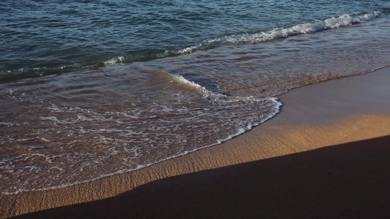 Small Waves breaking into whitewater across stretch of Waikiki Beach Hawaii Slow Motion