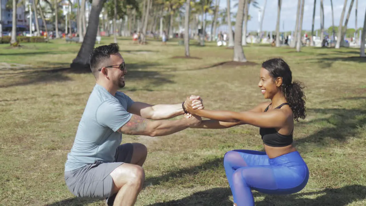 Cheerful couple working out in nature