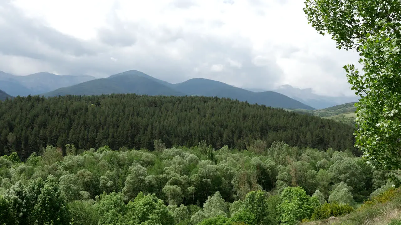 Spain Pyrenees Clouds Over Wooded Hills And Mountains