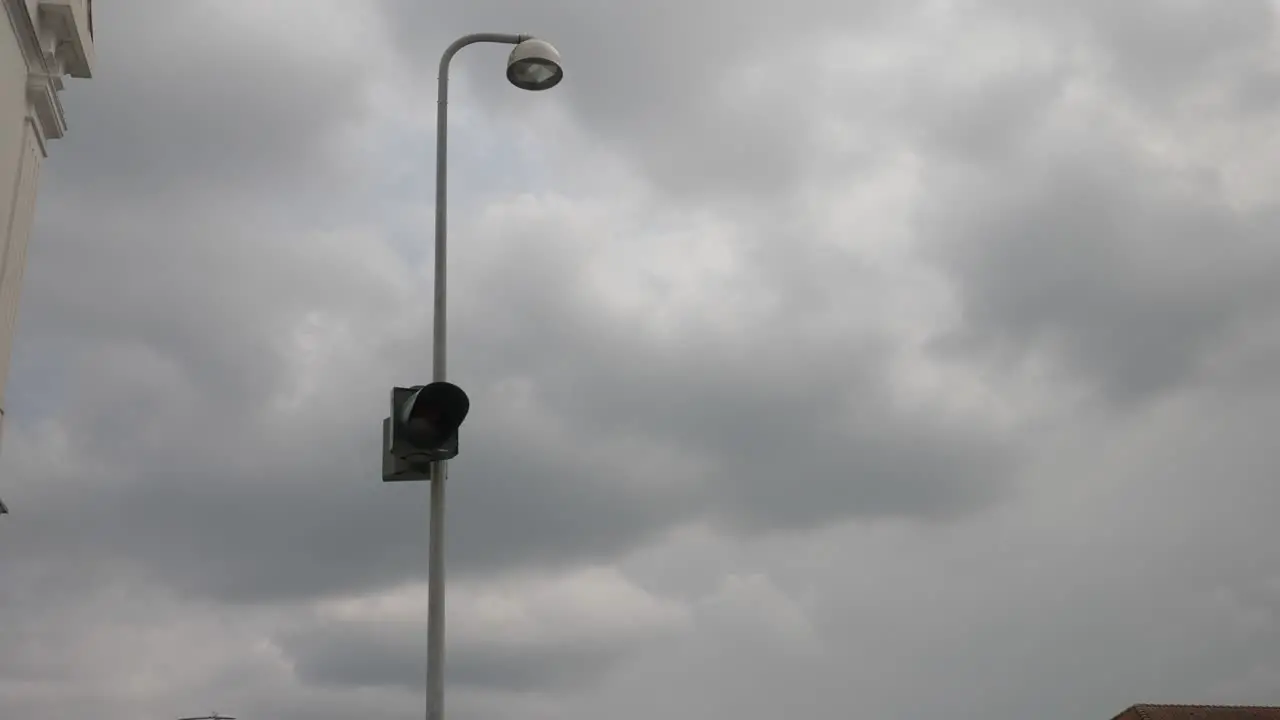 Street light flashes orange in cloudy weather