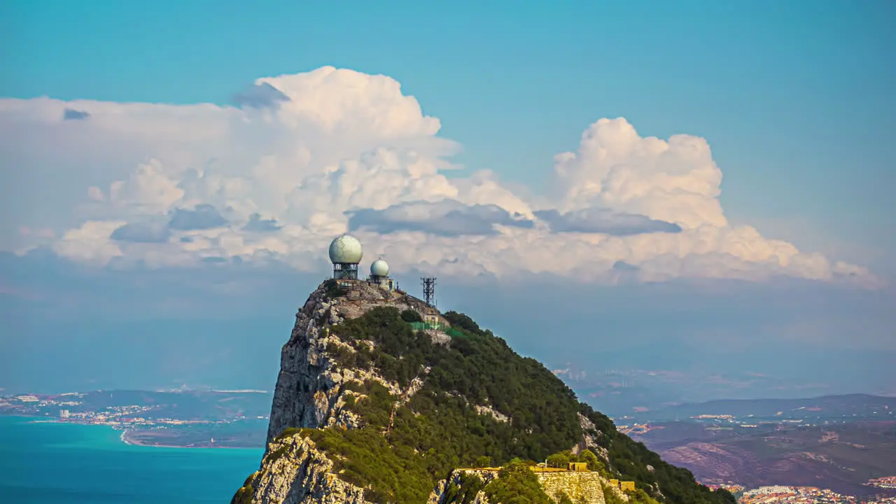 Moving clouds time lapse meteorological unit green landscape Gibraltar overlooking blue sea