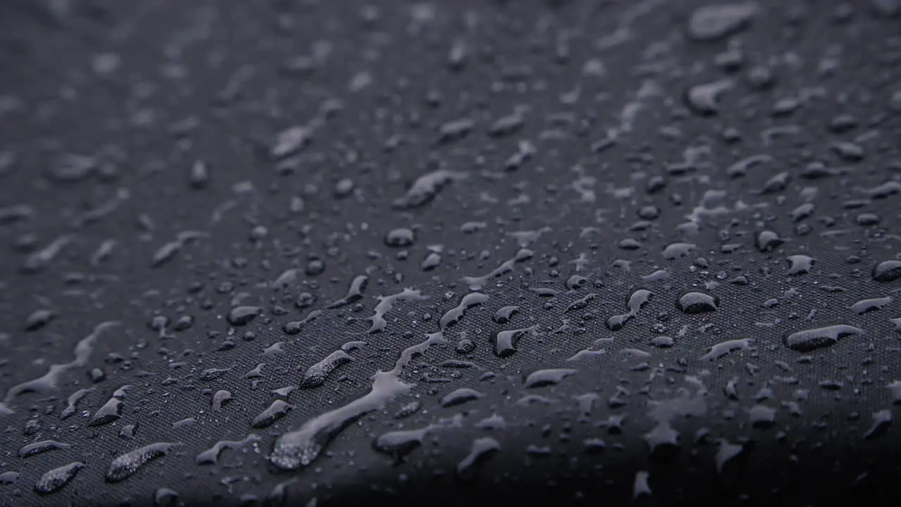 Heavy rain on black waterproof textile