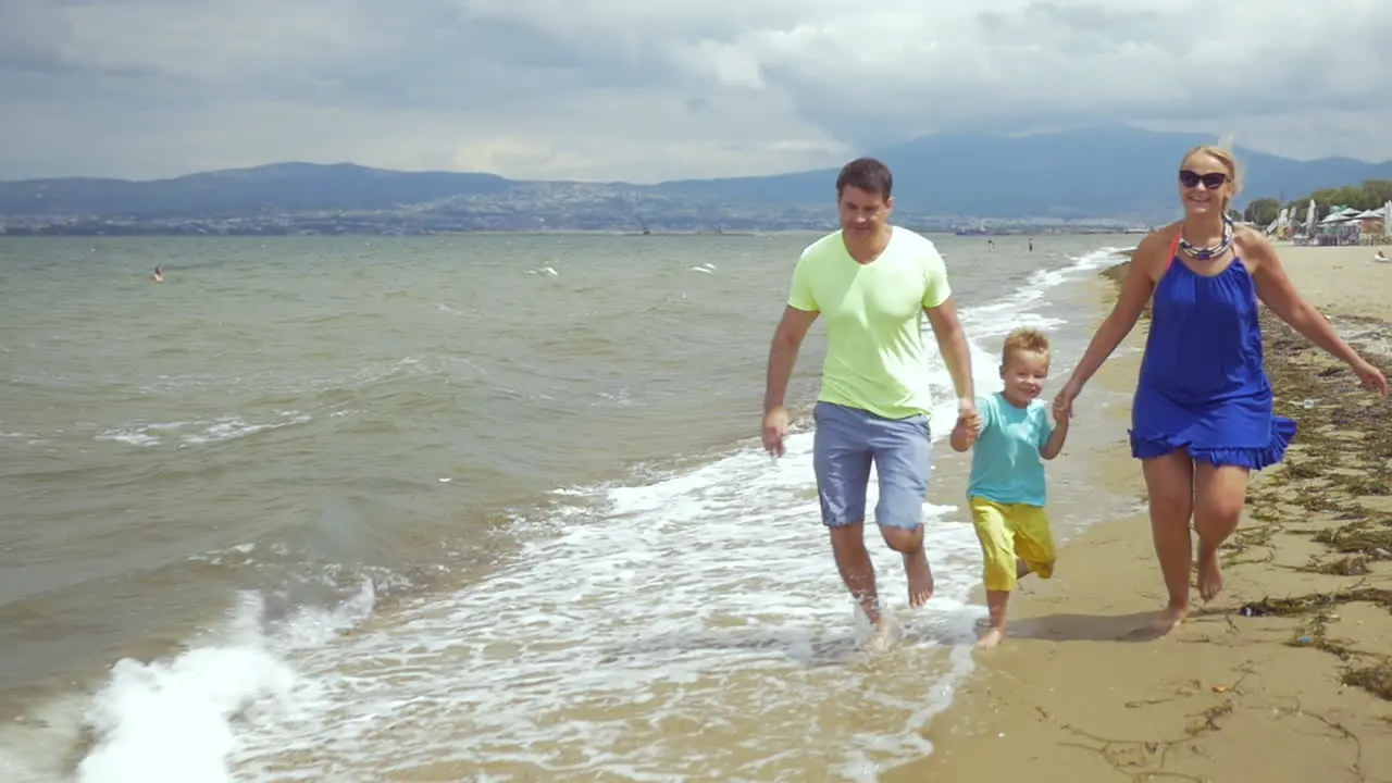 Happy family running on the seaside