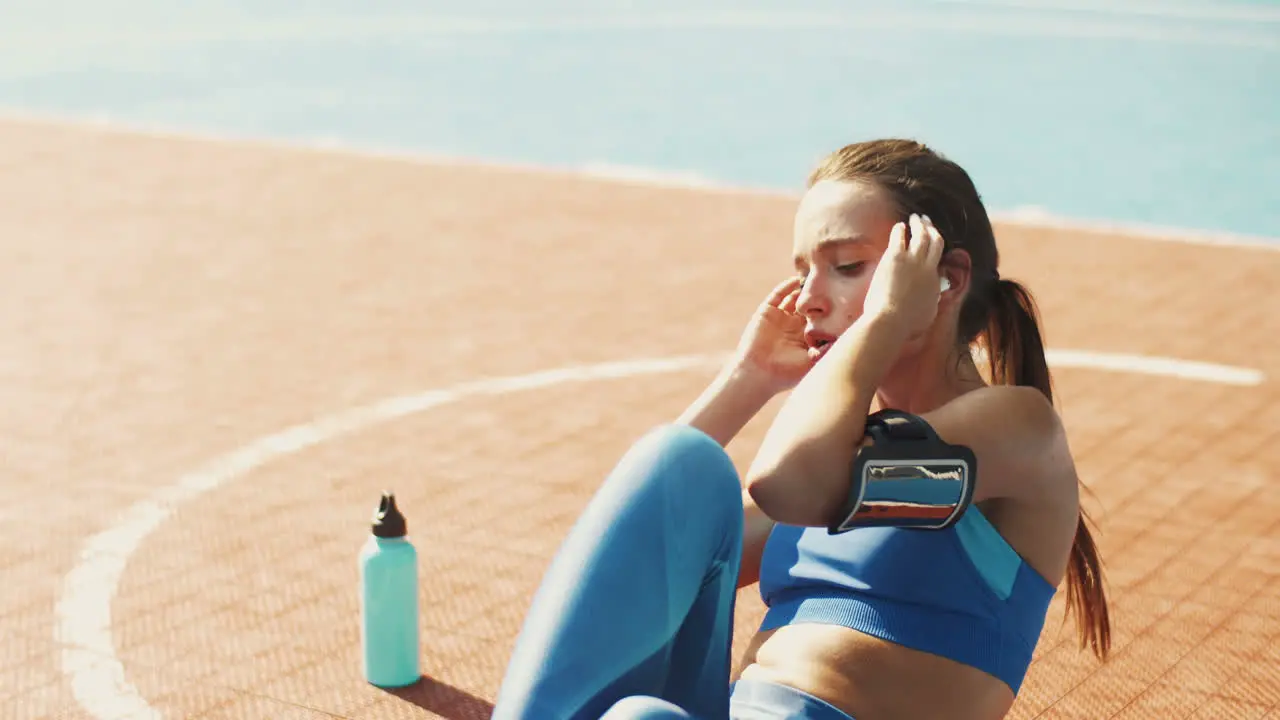 Sportswoman Doing Abs Crunches At Outdoor Court On A Summer Day