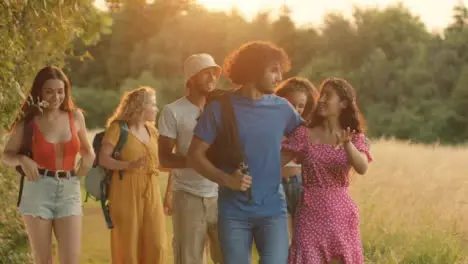 Tracking Shot of a Multi-Ethnic Group of Friends Walking at Sunset