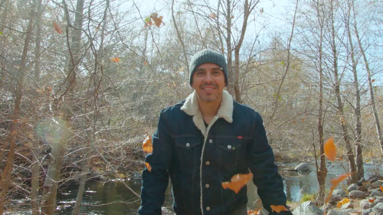 Throwing fall leaves into the air