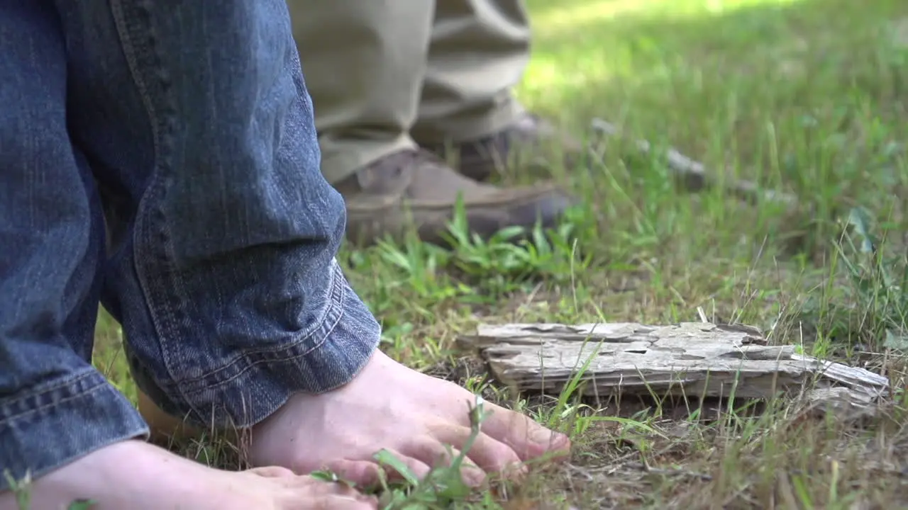 father and son fishing son is barefooted