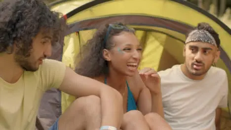 Panning Shot of Young Festival Goers Socialising by Their Tents