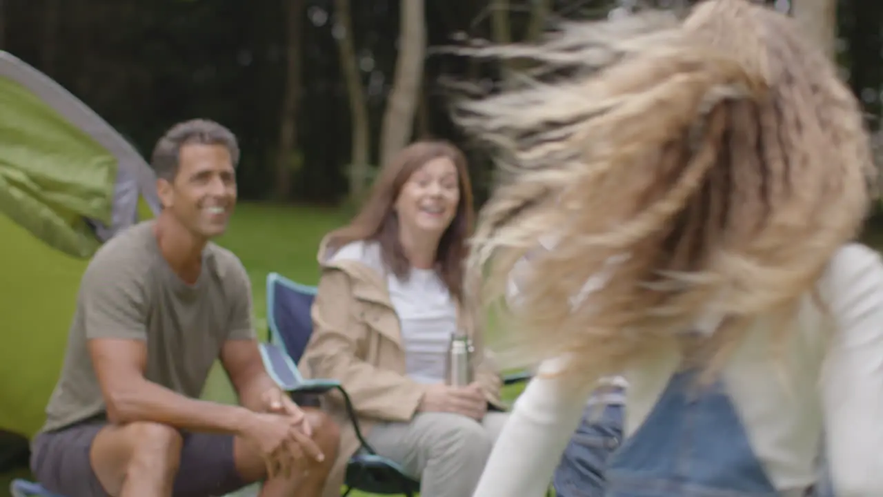 Tracking Shot Following Children Running to Their Family On Camping Trip