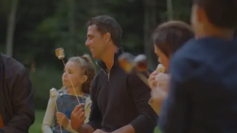 Long Shot of Family Sitting Around Campfire 03