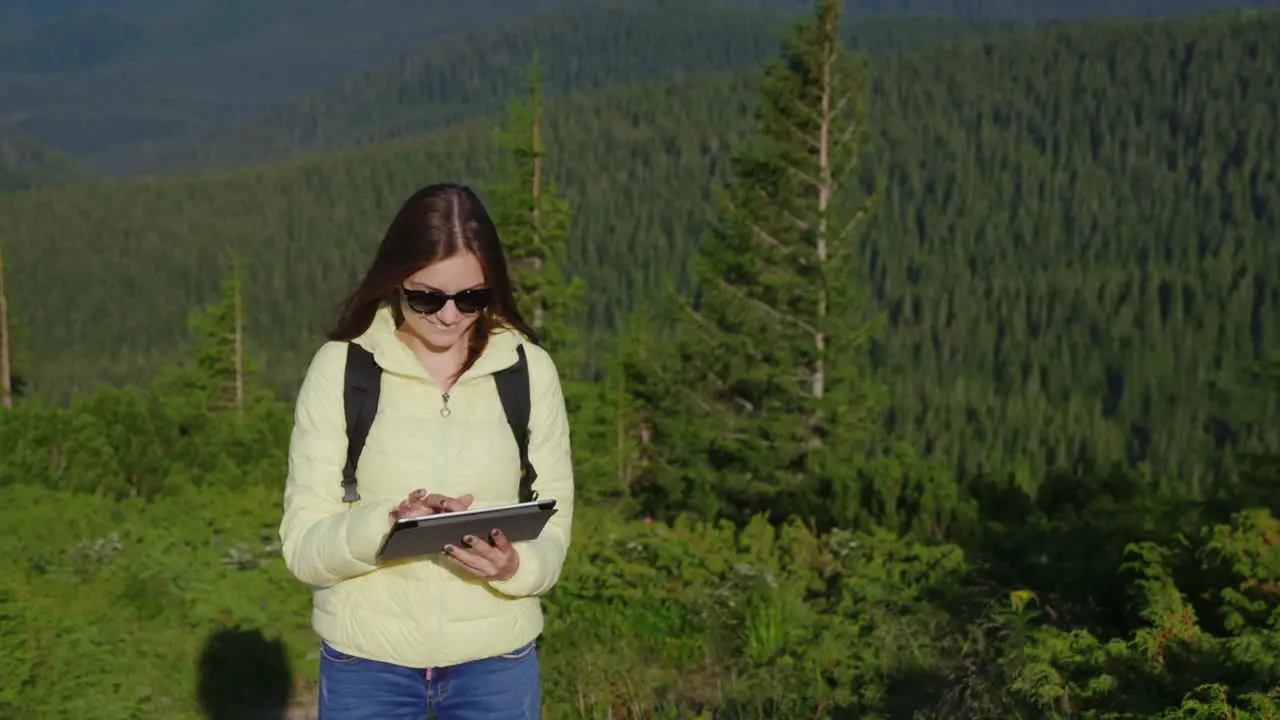 Young Woman Enjoying A Smartphone On A Picturesque Backdrop Of Mountains Covered With Forest Always 