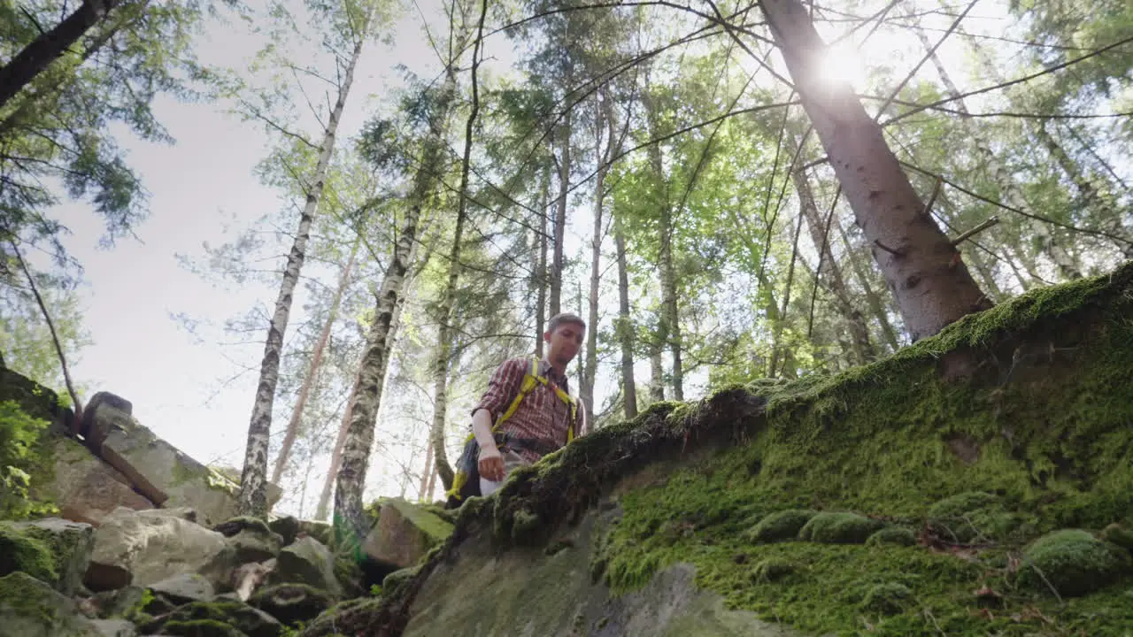 A Man With A Backpack Behind Him In A Hike Lower View Angle