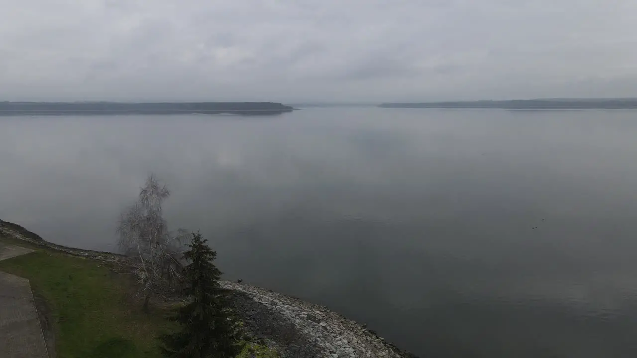 4k aerial drone footage of big lake in moody and gloomy weather