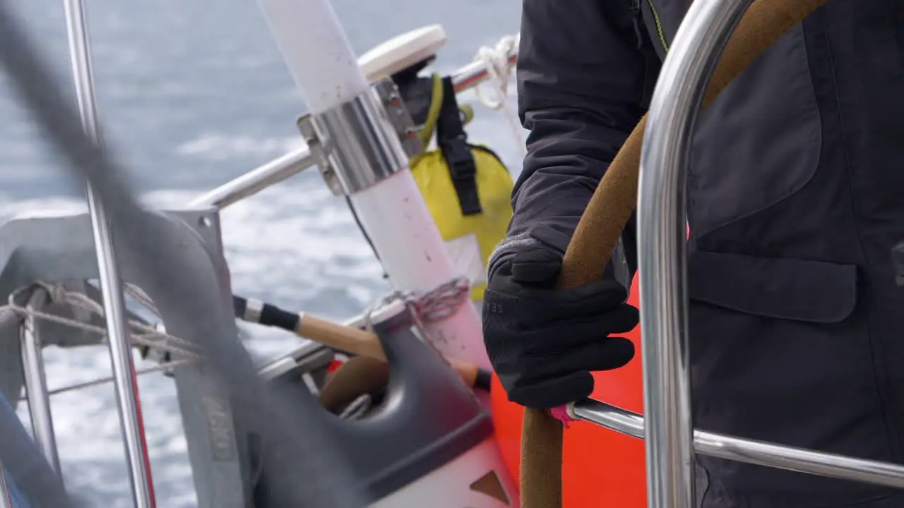 Hand steering a yacht while sailing in the Arctic