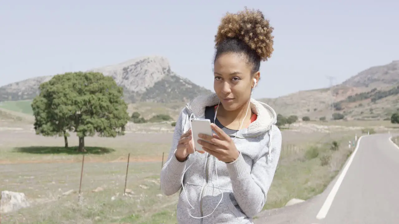 Pretty young sporty woman with phone