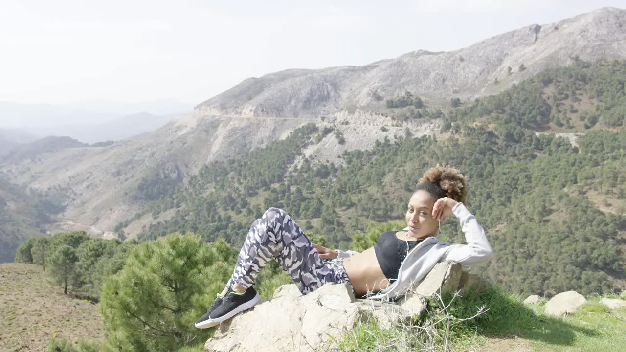 Relaxed young sportswoman taking rest