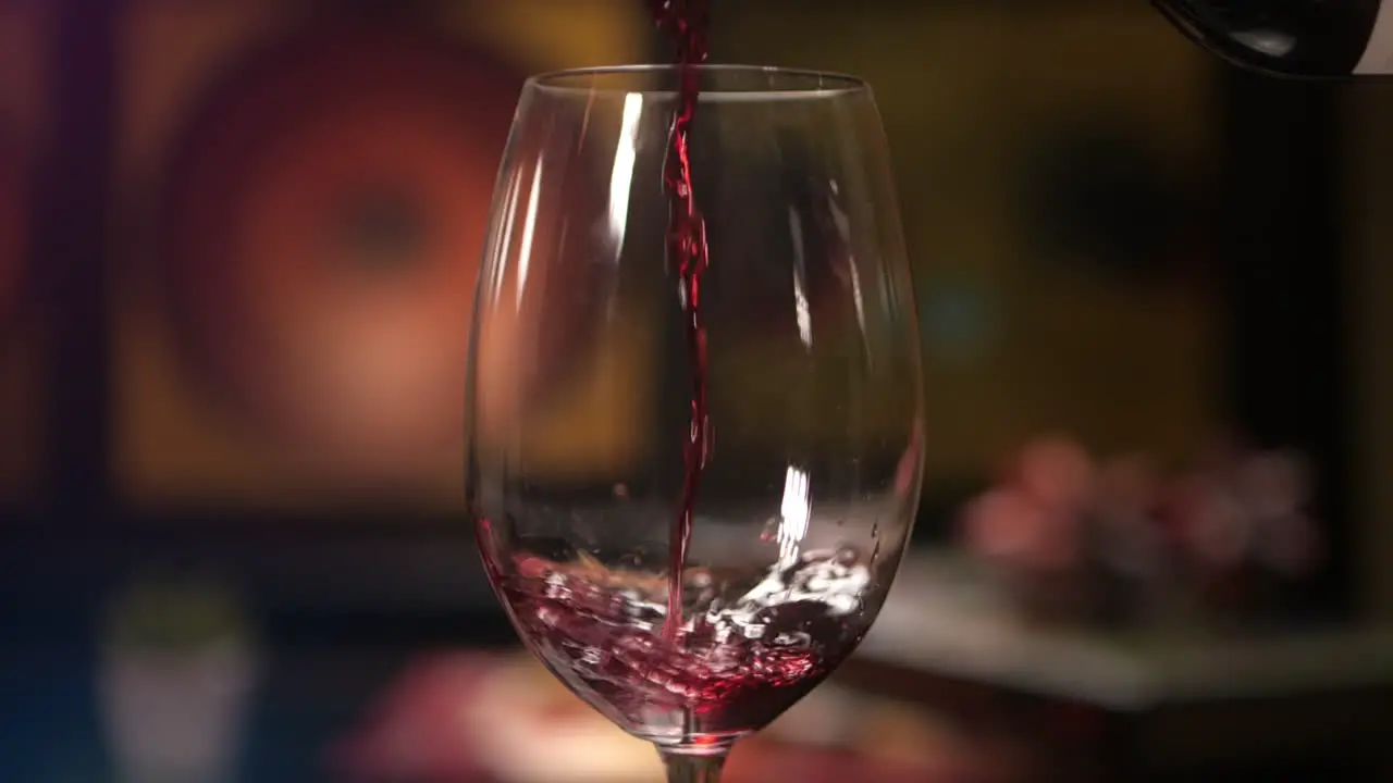 Slow Motion Red Wine Pouring into Wine Glass