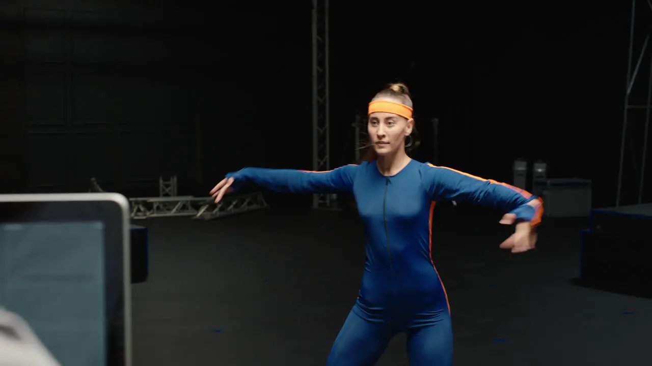 woman wearing motion capture suit dancing in studio ballet dancer girl wearing mo-cap suit for 3d character animation for virtual reality technology