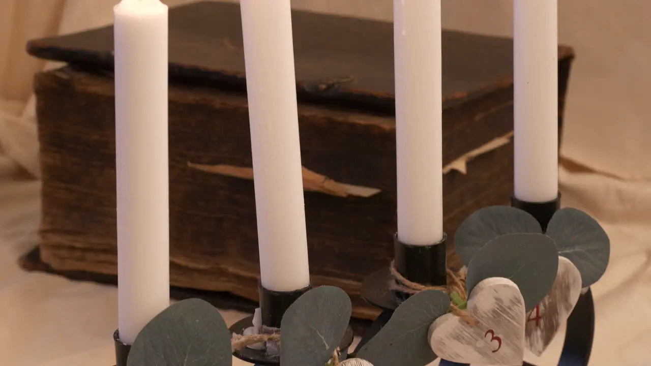 Four white candles burn in religious christian or spiritual setting