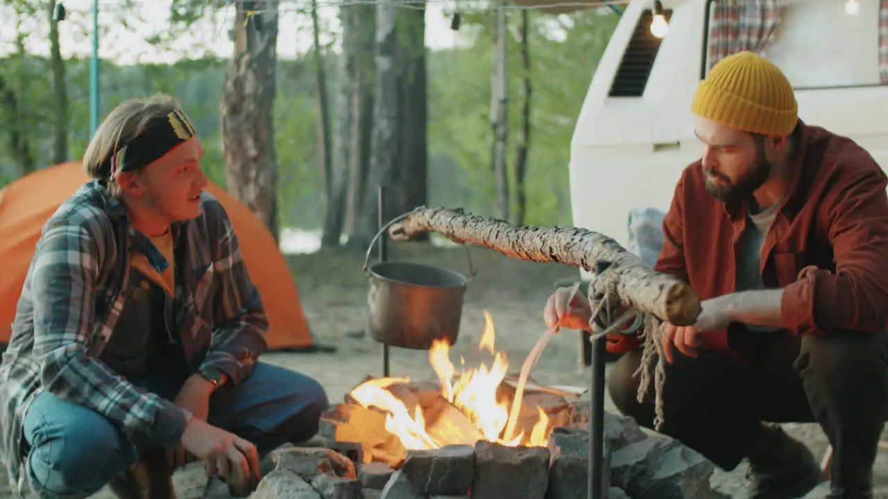 Young Men Talking by Campfire