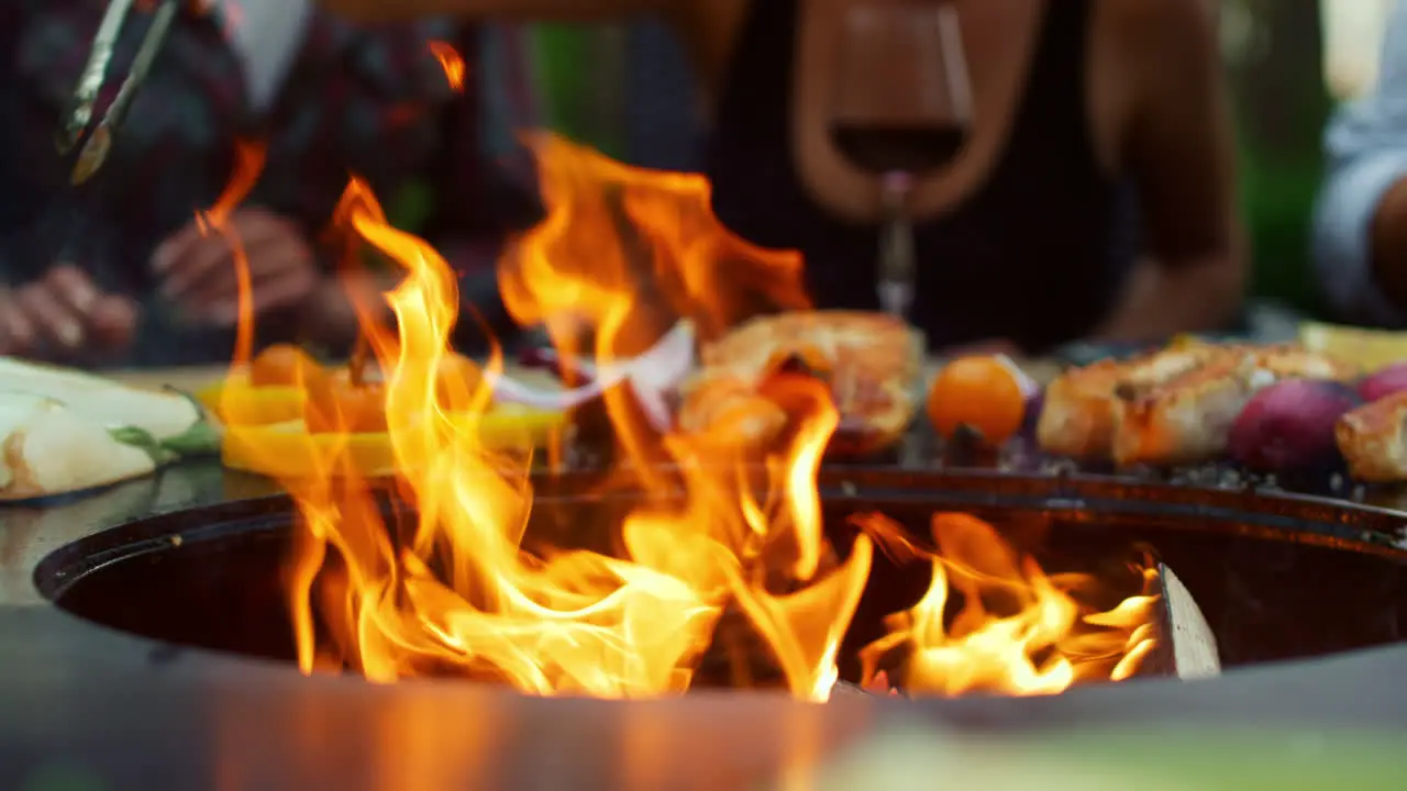 Closeup fire flames burning in bbq grill on backyard Vegetables cooking outdoor