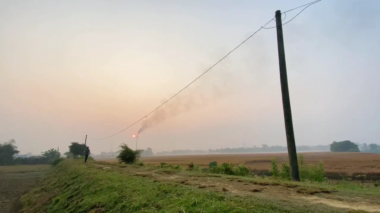 Bangladeshi young man jogging outdoor in rural countryside Industry behind