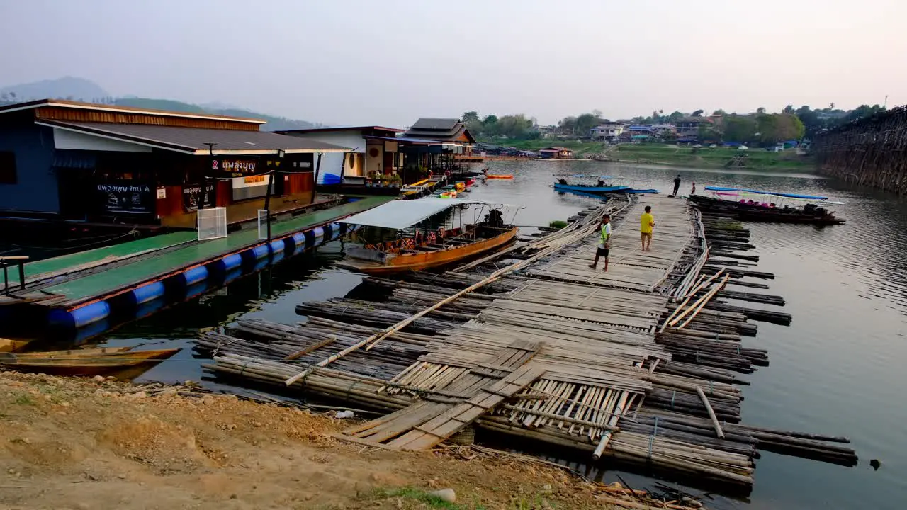 Floating homes and bamboo pathways Thai boats and people