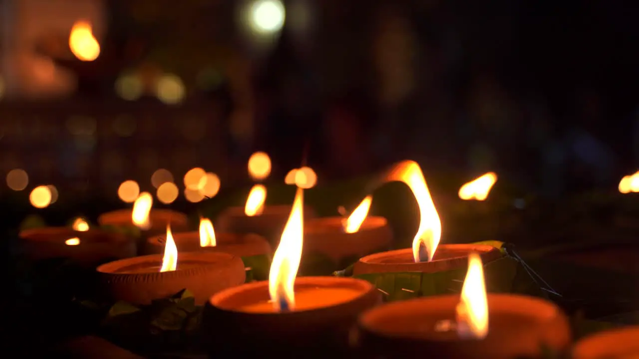 Close up rotating view of lit candles at night