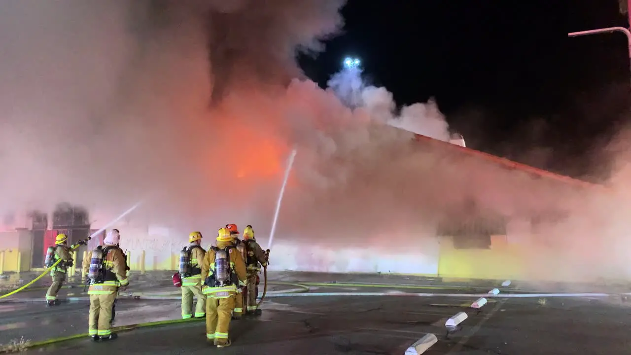 Firefighters work to put out a large building fire