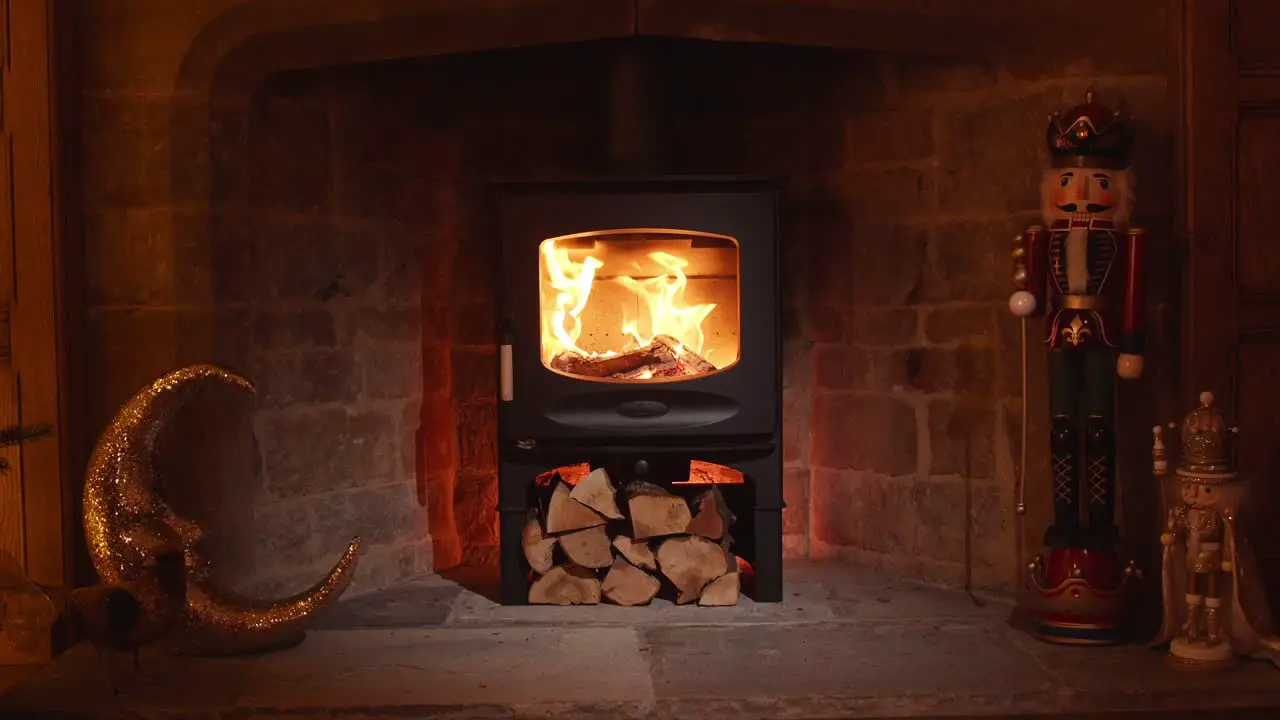 Lit wood burning stove in winter fireplace