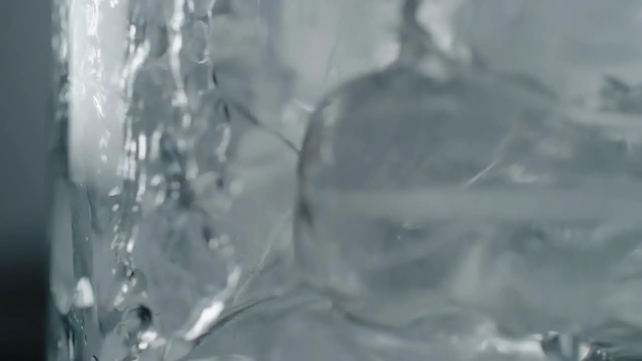 Pouring Water into a Frosty Glass with Ice