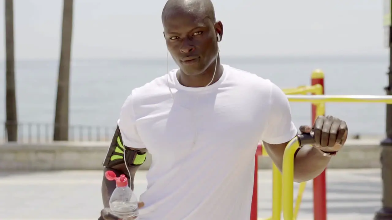 Athlete with uncapped sports bottle in park