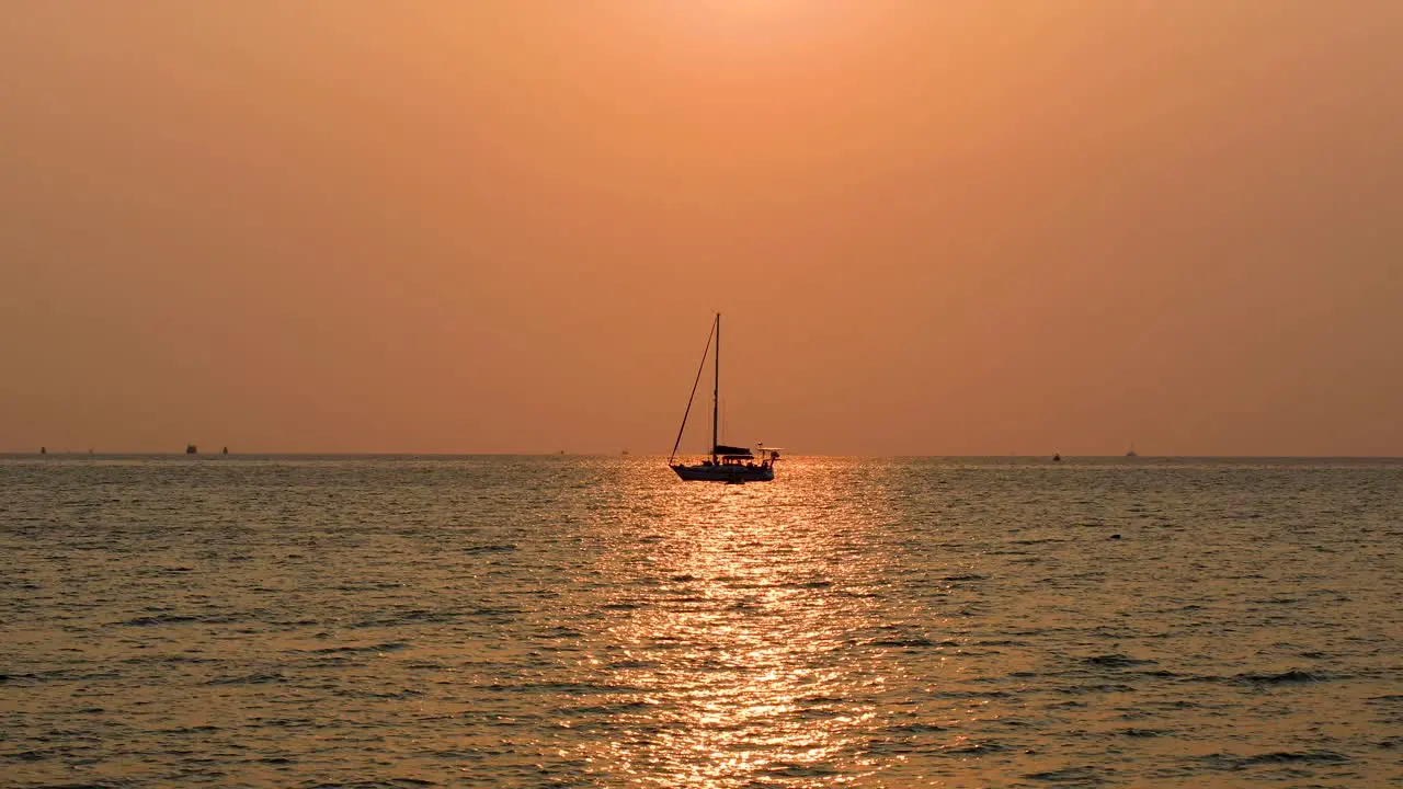 Amazing Sunset in Thailand with a Yacht on the Horizon with Pink and Orange Skies in Bangsaray near Pattaya