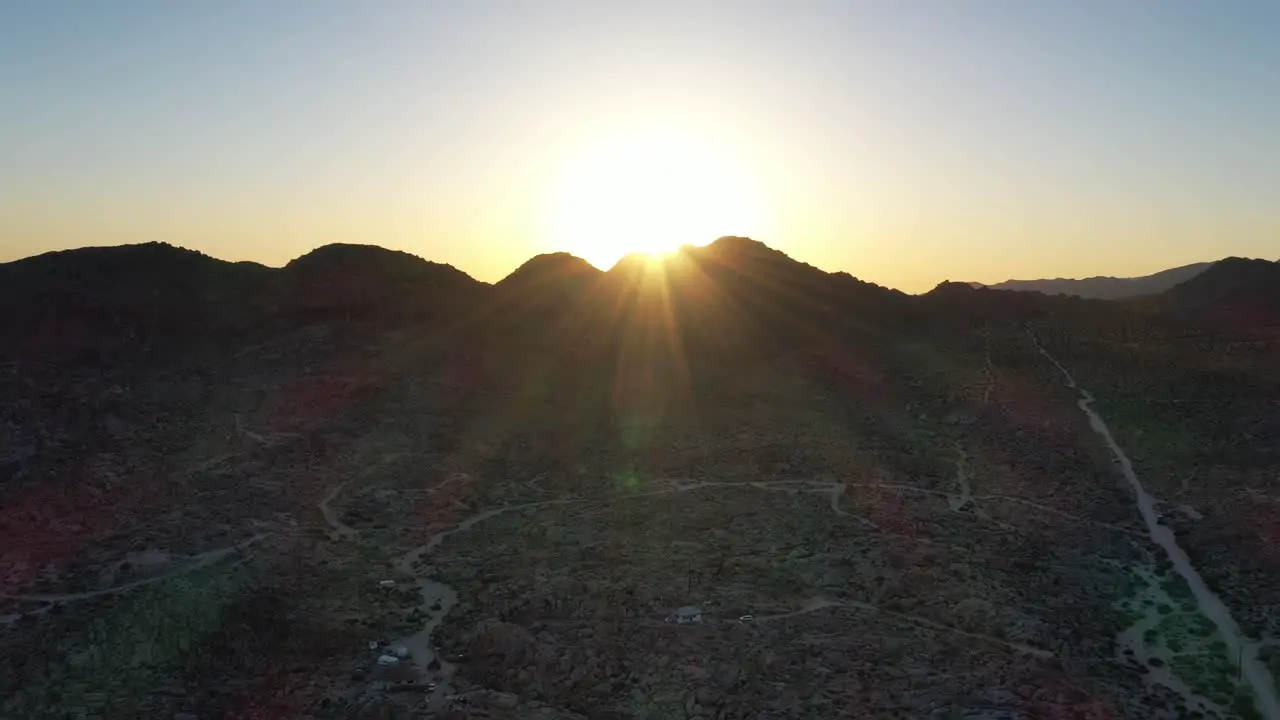 Bright Golden Sunset Over The Mountain With Desert Landscape In Foreground