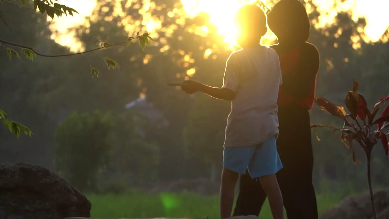 SLOW MOTION Children Playing on Edge of Rice Field in Sunset