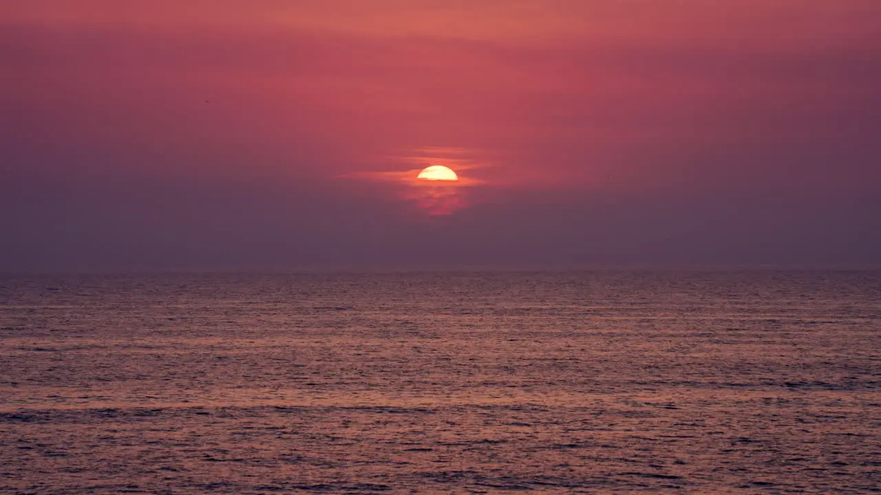 Aerial view of rippled water surface of sea on sunset