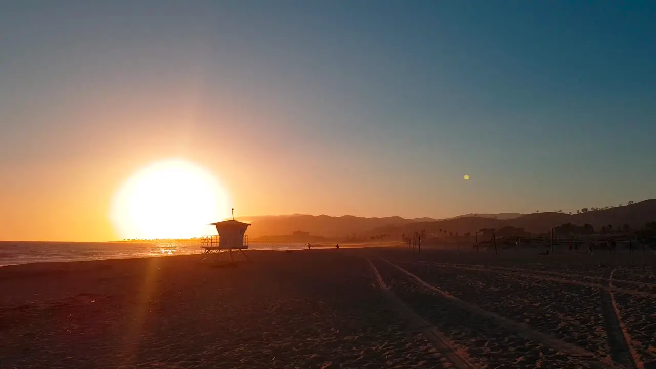 Slow panoramic sunset shot of San Buenaventura State Beach with Lifeguard house  tower in Ventura California United States