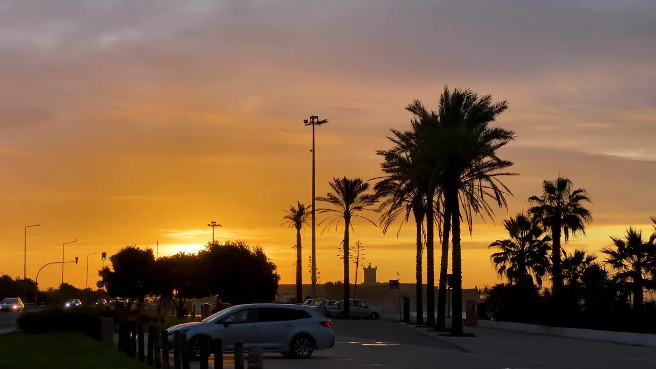 zoom in of city urban street with cars sunrise buildings