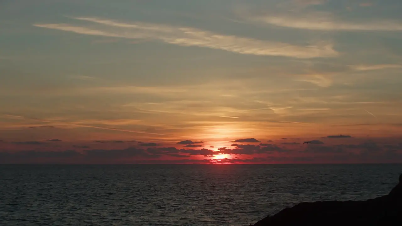 Glowing Ocean Sunset With Silhouette of Flying Seagull Bird Slowly Comes into View Slow Motion