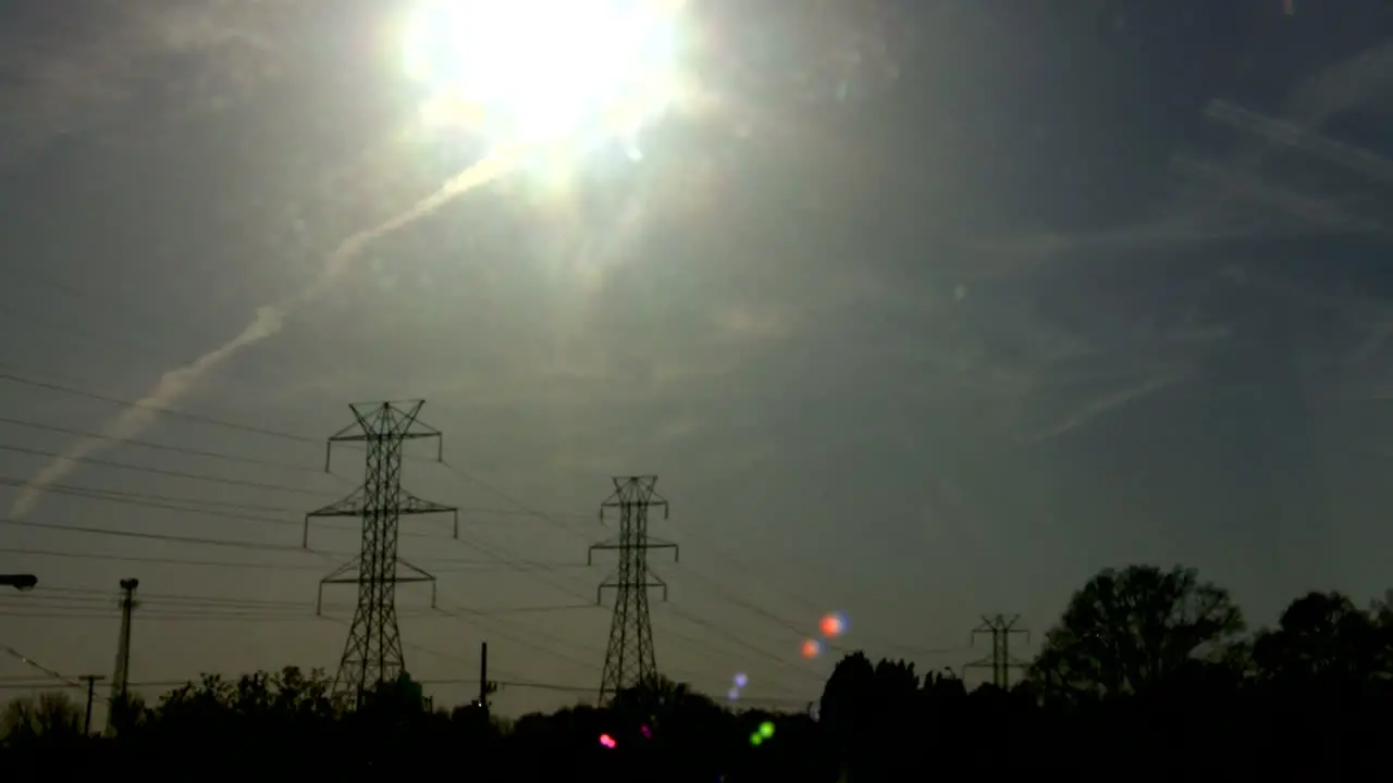 Time lapse of the sun setting behind power lines